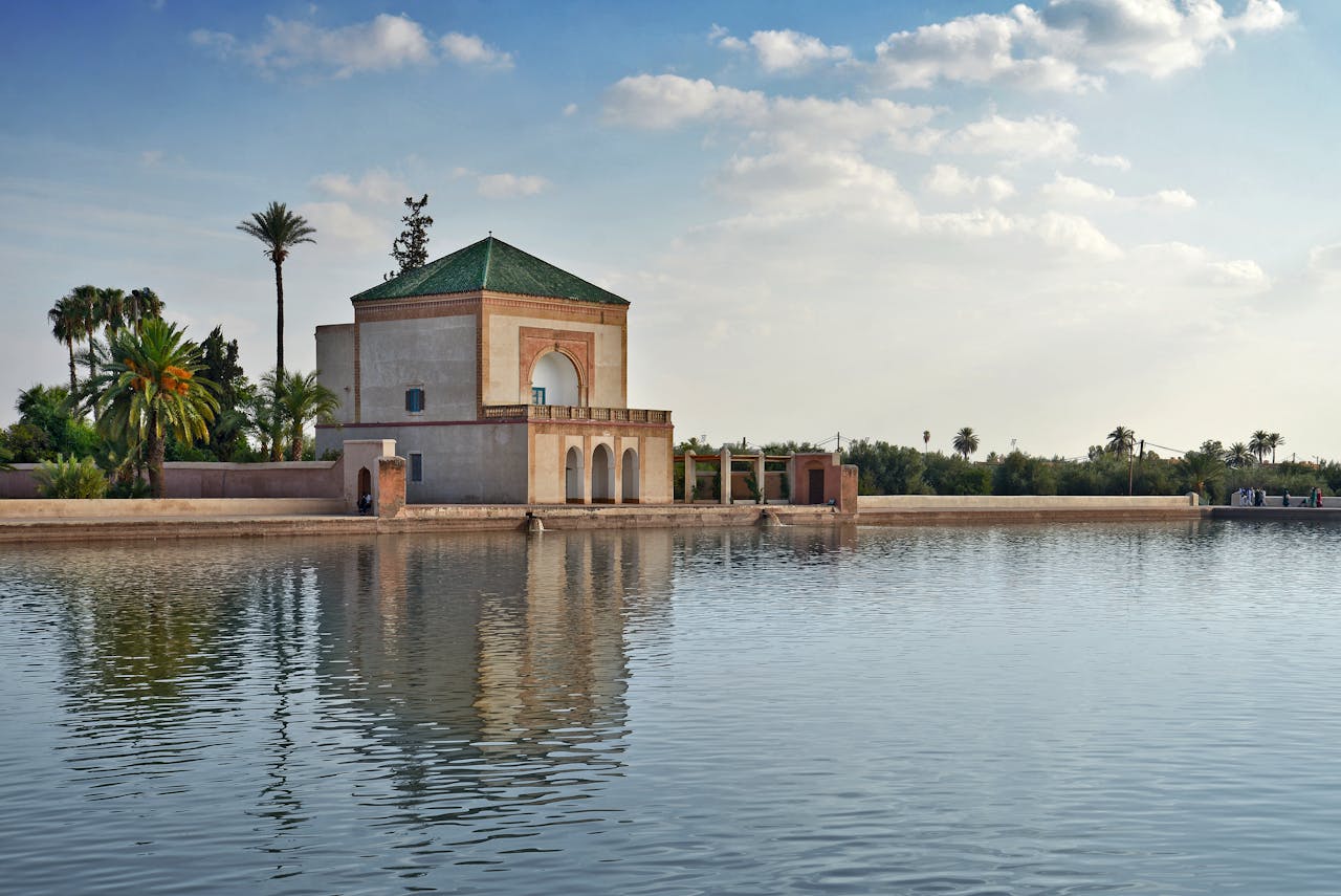 A serene view of Menara Gardens Pavilion reflecting on tranquil waters in Marrakech.